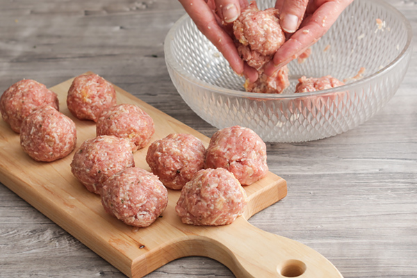 Rolling meatballs.